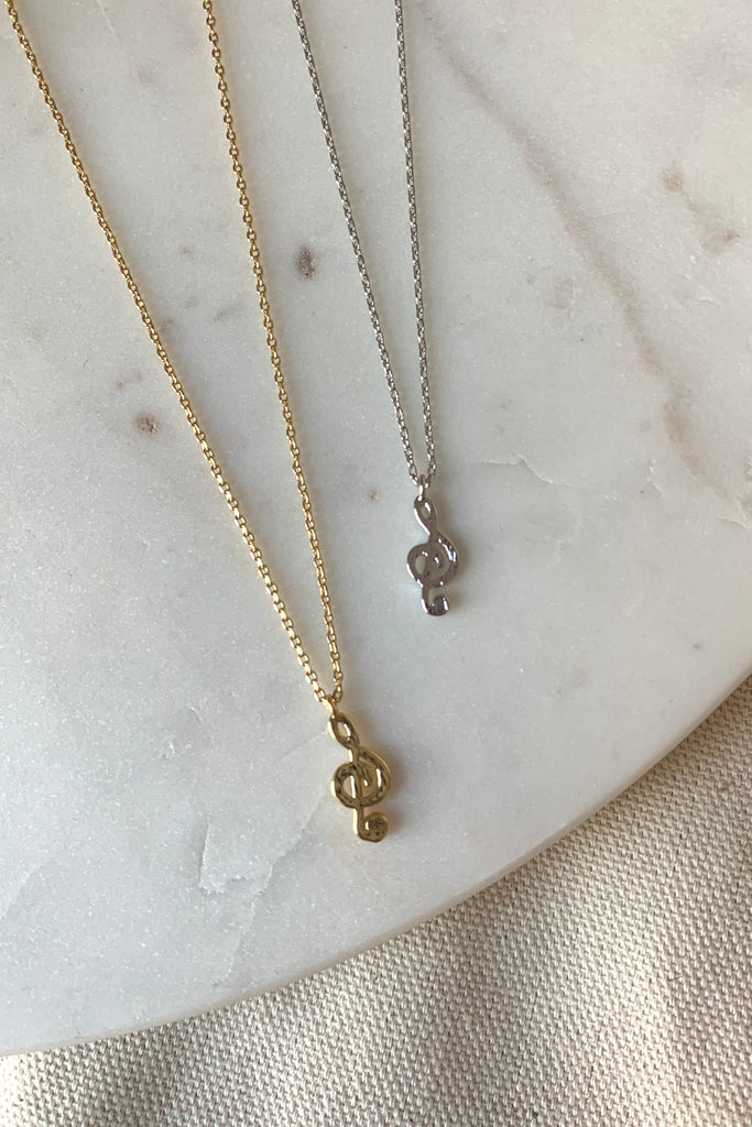 Show off your musical love with this dainty treble clef necklace, available in two shiny colors: gold and silver. Perfect for any occasion and music lovers alike!