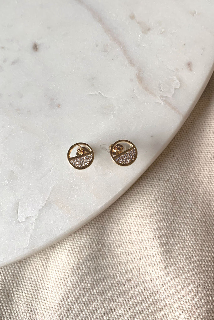 Add an elevated touch to any outfit with the Half Circle Pave Stud earrings. Crafted with gold dipped metal, these beautiful studs shimmer with a subtle sparkle and are sure to be a timeless classic.
