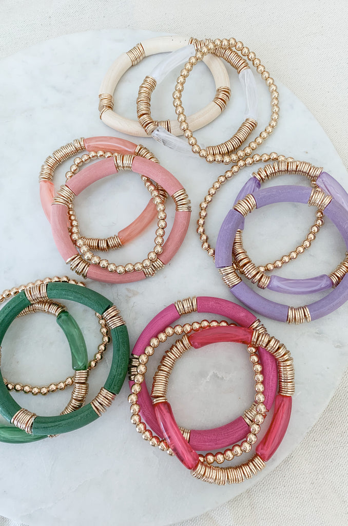 This 3 Strand Wood & Resin Bracelet is the perfect accessory for everyday wear. Crafted with wood and resin plus a gold beads, it features a variety of fun colors to add a touch of personality to any outfit. 