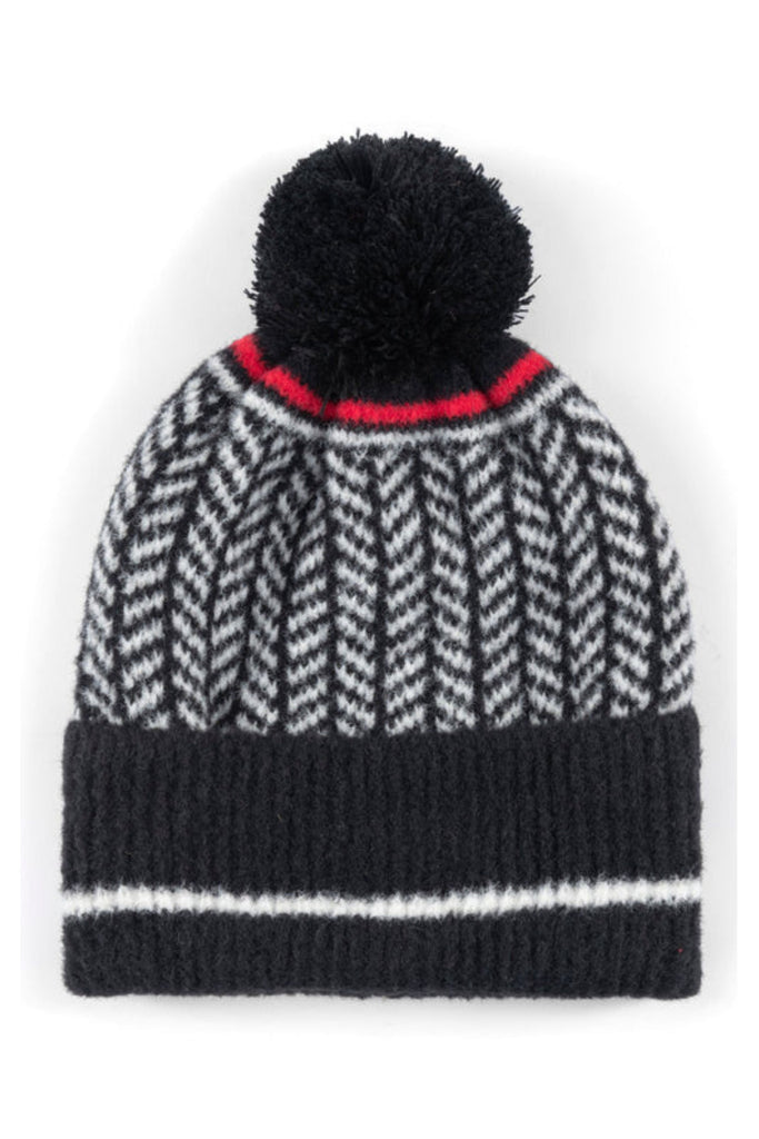 Spruce up your cold weather accessories in Shiraleah's Bowie Hat. This hat features a cozy knit texture in a black and white herringbone design with a pop of red color, making it the perfect addition to any winter outfit. Made from nylon and acrylic, and featuring a pompom detail, the Bowie Hat will keep you cozy and chic during the cold winter months. Pair it with other Shiraleah accessories to complete your winter look!