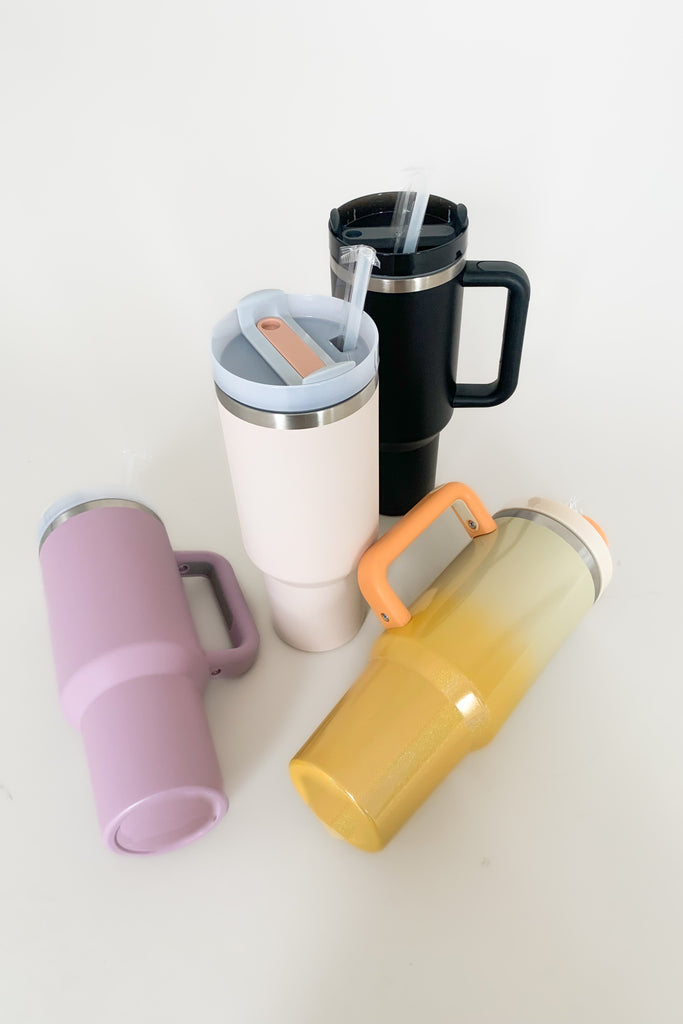 Stay hydrated in style with our 40 oz Quencher Cup! It's stainless steel, BPA Free with double wall vacuum insulation! This cup features an ergonomic handle with comfortable grip. It also features a reusable straw, is dishwasher safe, and fits in most car cup holders.