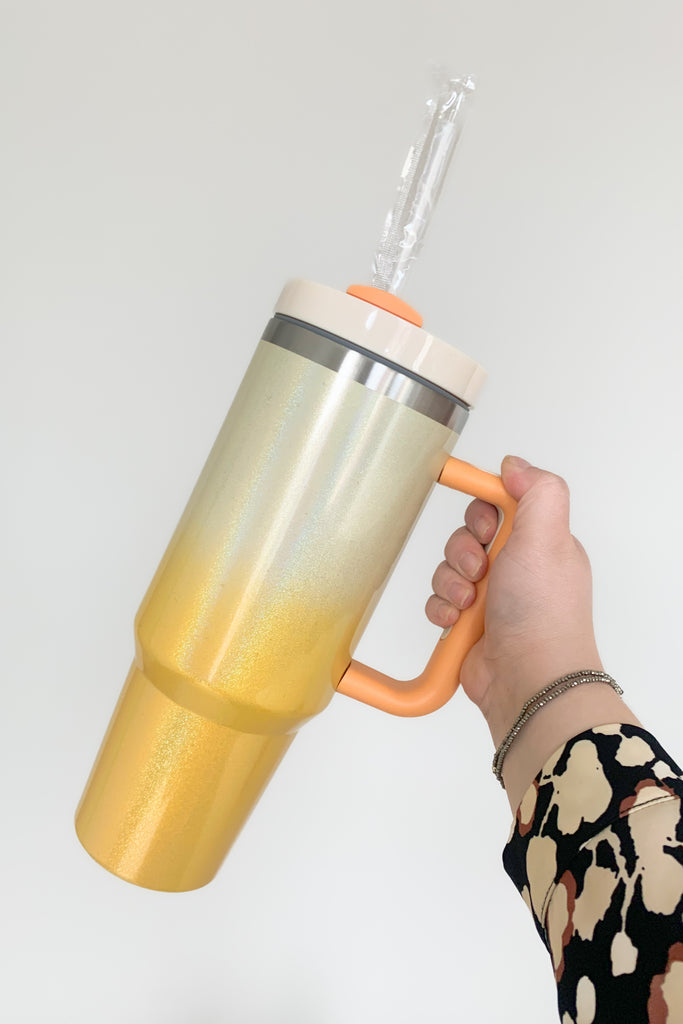Stay hydrated in style with our 40 oz Quencher Cup! It's stainless steel, BPA Free with double wall vacuum insulation! This cup features an ergonomic handle with comfortable grip. It also features a reusable straw, is dishwasher safe, and fits in most car cup holders.