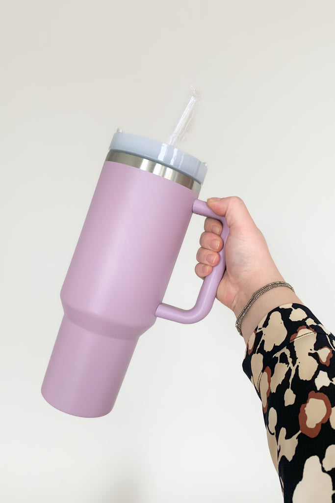 Stay hydrated in style with our 40 oz Quencher Cup! It's stainless steel, BPA Free with double wall vacuum insulation! This cup features an ergonomic handle with comfortable grip. It also features a reusable straw, is dishwasher safe, and fits in most car cup holders.
