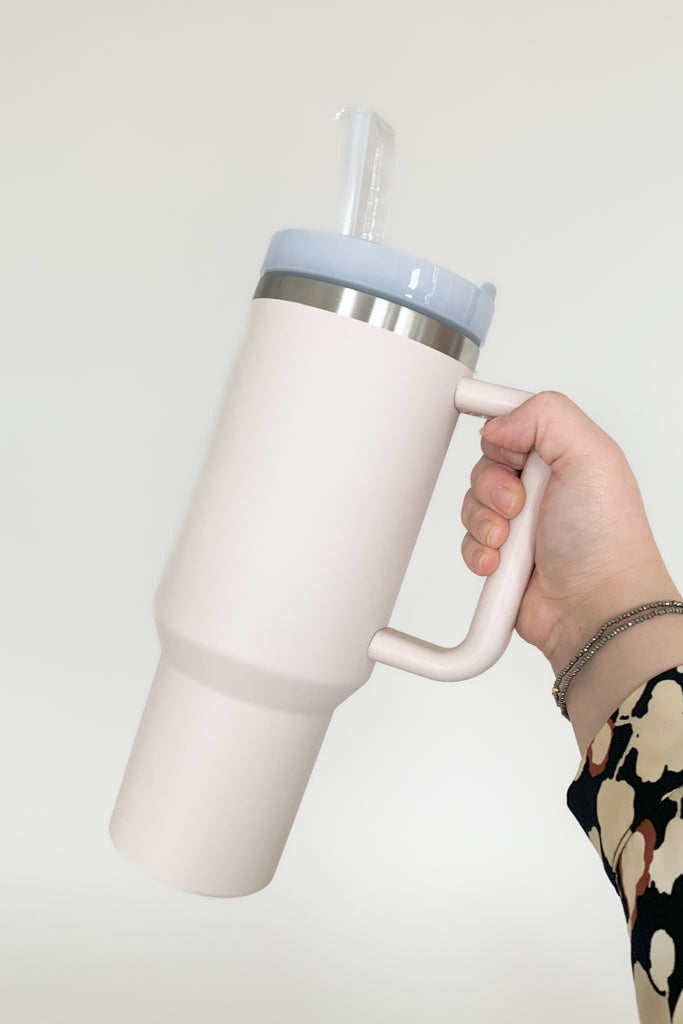 Stay hydrated in style with our 40 oz Quencher Cup! It's stainless steel, BPA Free with double wall vacuum insulation! This cup features an ergonomic handle with comfortable grip. It also features a reusable straw, is dishwasher safe, and fits in most car cup holders.