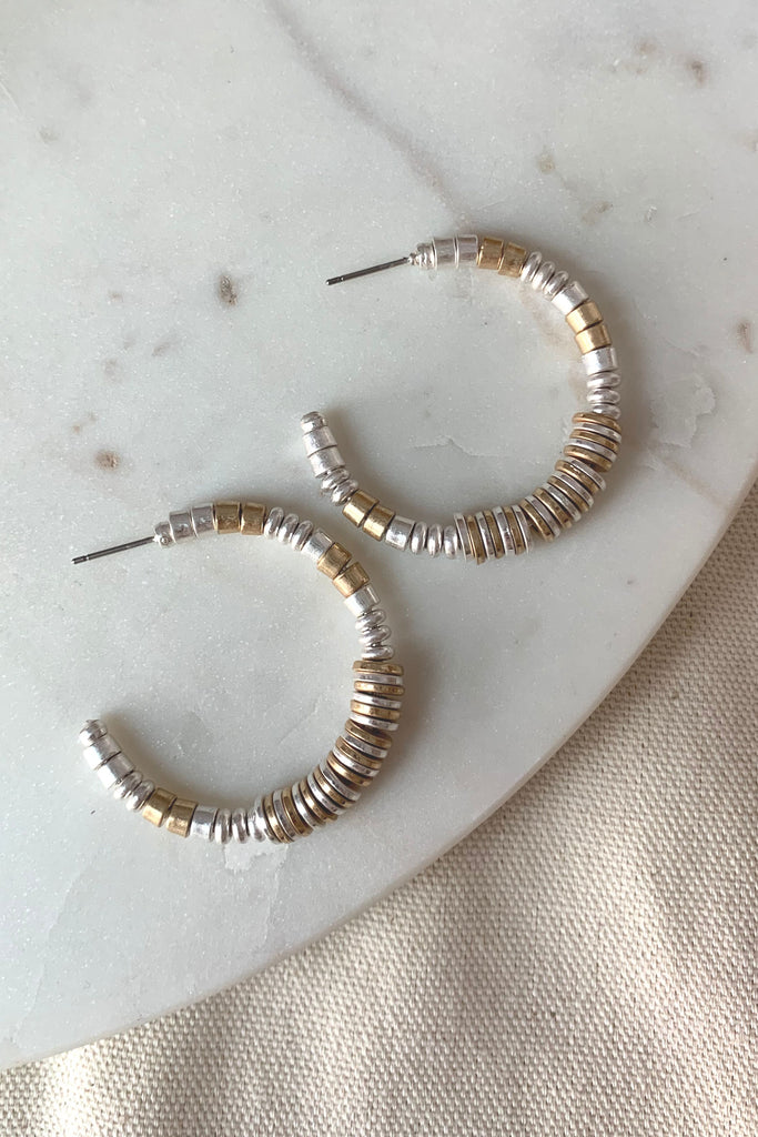 This Mixed Metal Pieces Open Hoop is an incredibly stylish and modern accessory. Combining sleek materials and classic hoop design, it will instantly upgrade any look. It's lightweight and hypoallergenic too. 