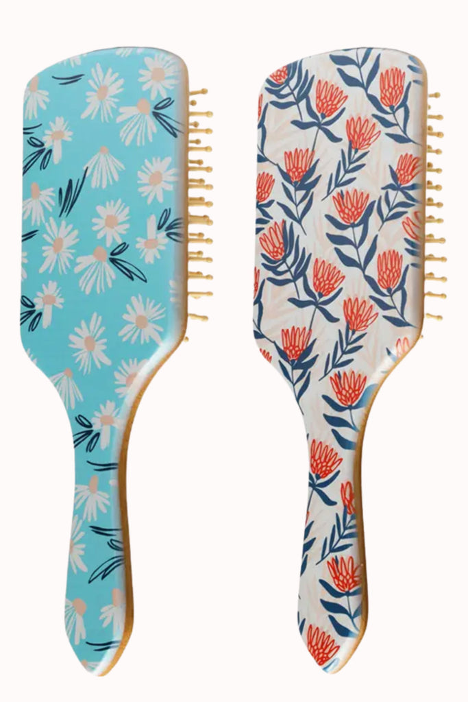 This Bamboo Hair Brush is a fun sticking stuffer for the holidays! The design is super cute, featuring a bamboo handle and soft bristle brush. Choose between blue or blue/red floral. 
