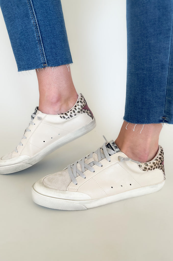 Meet the Amber Beige Sneakers with Cheetah Patch! These on-trend sneakers feature a beige leather, suede tongue, and a distressed rubber sole for a comfortable and stylish look. The cheetah patch with a star on the back adds a fun, unique touch. Step into the season with a good pair of sneakers! 