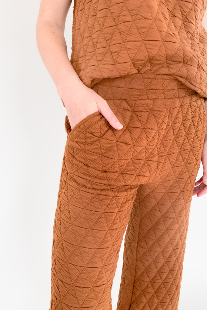 Stay warm and stylish with the Ashlee Quilted Pants! These medium weight lounger pants boast a textured fabric and feature an elastic waistband, side pockets, and wide leg fit.