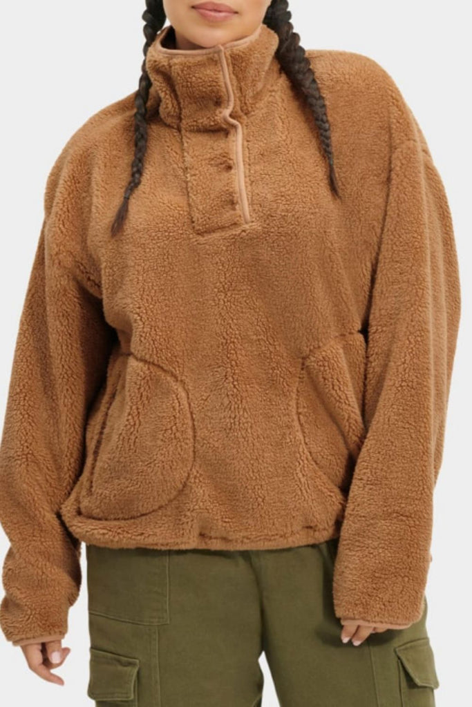 The UGG Atwell Sherpa Half Snap Pullover offers an effortless cozy style! Featuring a bold stand collar with snap closures and zip pockets, it will pair perfectly with your favorite bottoms and boots. It's cute, casual, and oh so cozy!