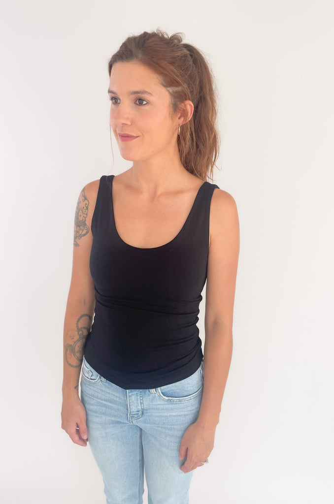 The Bon Basic Scoop Neck Tank is the ultimate layering piece, or wear it on its own for all-day comfort. It's lightweight, soft, stretchy, and semi-fitted. The scoop neck is very flattering too. It looks elevated and will layer well under anything! Plus, it is double-lined for more coverage. 