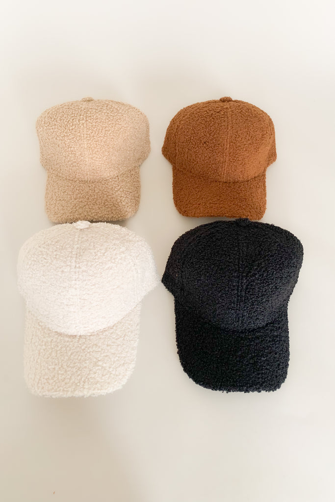 The Boucle Baseball Cap is a cute & trendy style that takes a casual hat to the next level! They are anything but boring, featuring a unique sherpa texture and cozy fit. These hats have an adjustable back too. 