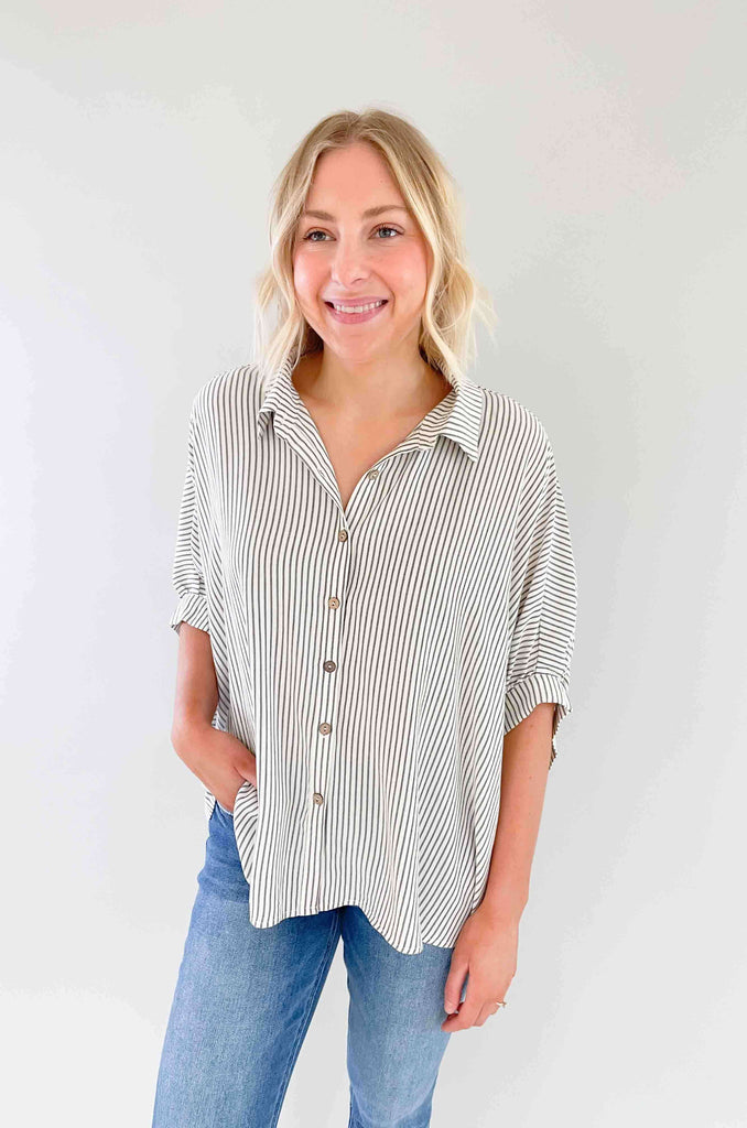 Look sharp and stylish in our Brayden Boxy Striped Button Down! This unique shirt features 3/4 balloon-like sleeves, a collared detail, and a button up front. Plus, the black and off-white stripes are timeless. Its flowy body will keep you feeling as cool as you'll look! The fabric is lightweight too with a special textured design. Try this must-have if you love effortless style. 