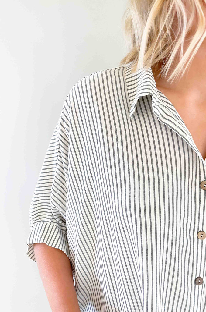 Look sharp and stylish in our Brayden Boxy Striped Button Down! This unique shirt features 3/4 balloon-like sleeves, a collared detail, and a button up front. Plus, the black and off-white stripes are timeless. Its flowy body will keep you feeling as cool as you'll look! The fabric is lightweight too with a special textured design. Try this must-have if you love effortless style. 