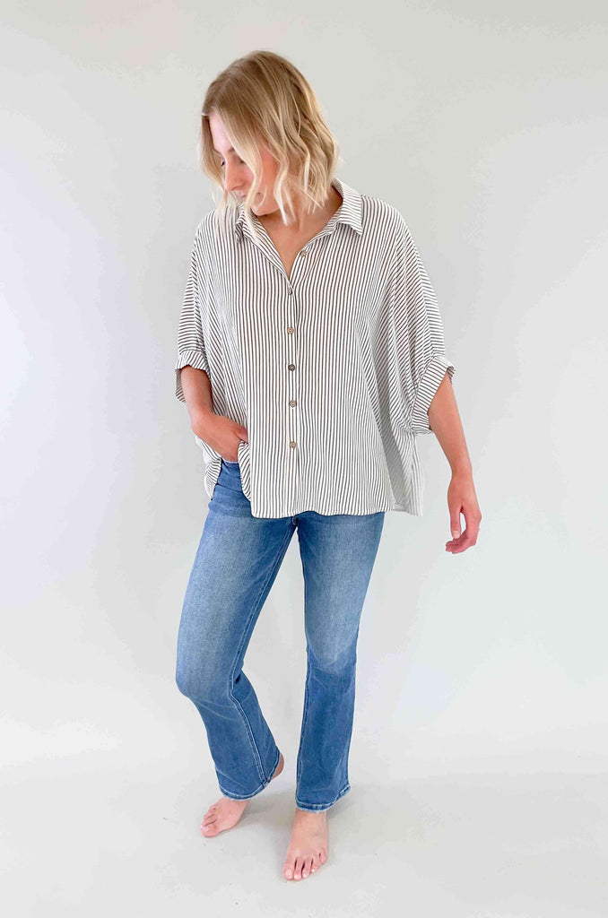Look sharp and stylish in our Brayden Boxy Striped Button Down! This unique shirt features 3/4 balloon-like sleeves, a collared detail, and a button up front. Plus, the black and off-white stripes are timeless. Its flowy body will keep you feeling as cool as you'll look! The fabric is lightweight too with a special textured design. Try this must-have if you love effortless style. 