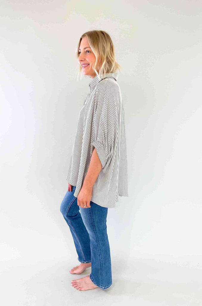 Look sharp and stylish in our Brayden Boxy Striped Button Down! This unique shirt features 3/4 balloon-like sleeves, a collared detail, and a button up front. Plus, the black and off-white stripes are timeless. Its flowy body will keep you feeling as cool as you'll look! The fabric is lightweight too with a special textured design. Try this must-have if you love effortless style. 