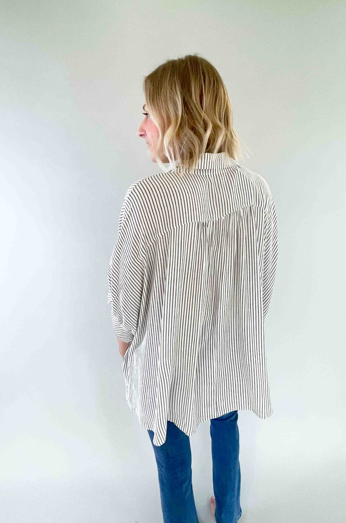 Look sharp and stylish in our Brayden Boxy Striped Button Down! This unique shirt features 3/4 balloon-like sleeves, a collared detail, and a button up front. Plus, the black and off-white stripes are timeless. Its flowy body will keep you feeling as cool as you'll look! The fabric is lightweight too with a special textured design. Try this must-have if you love effortless style. 