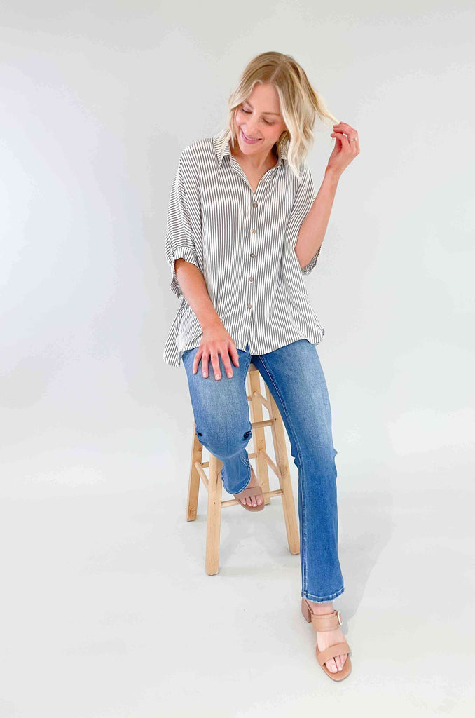 Look sharp and stylish in our Brayden Boxy Striped Button Down! This unique shirt features 3/4 balloon-like sleeves, a collared detail, and a button up front. Plus, the black and off-white stripes are timeless. Its flowy body will keep you feeling as cool as you'll look! The fabric is lightweight too with a special textured design. Try this must-have if you love effortless style. 