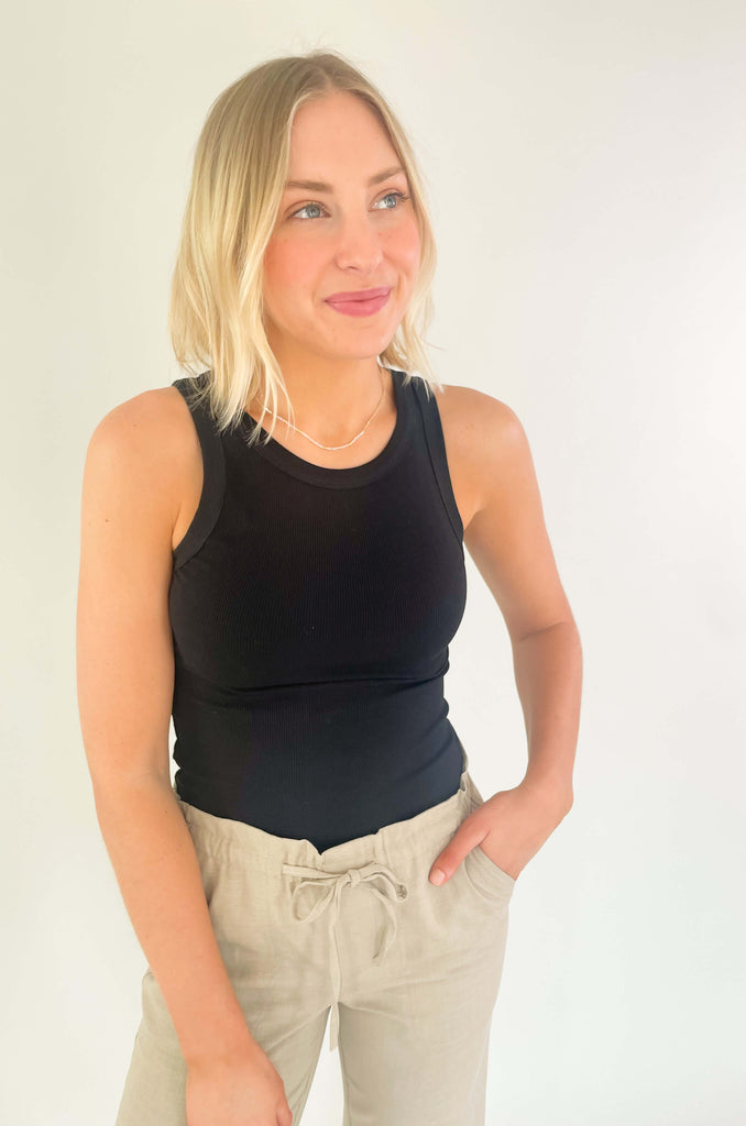Introducing our Breanna Binding Tank Top - the perfect partner in fashion for all your hot weather escapades! It's soft, stretchy fabric is designed to keep you comfortable and looking cool, while its ribbed texture gives it an elevated touch of class. Choose between brown and black
