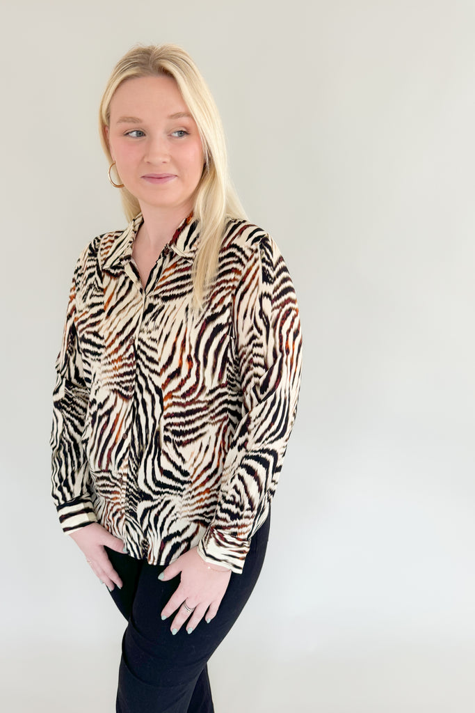 Make a statement with this chic animal print woven blouse by Liverpool!  Featuring a button front and patchwork design, this top is stylish and comfortable.We love the mixed zebra inspired print too. It's so fun, plus the fabric feels super silky soft!