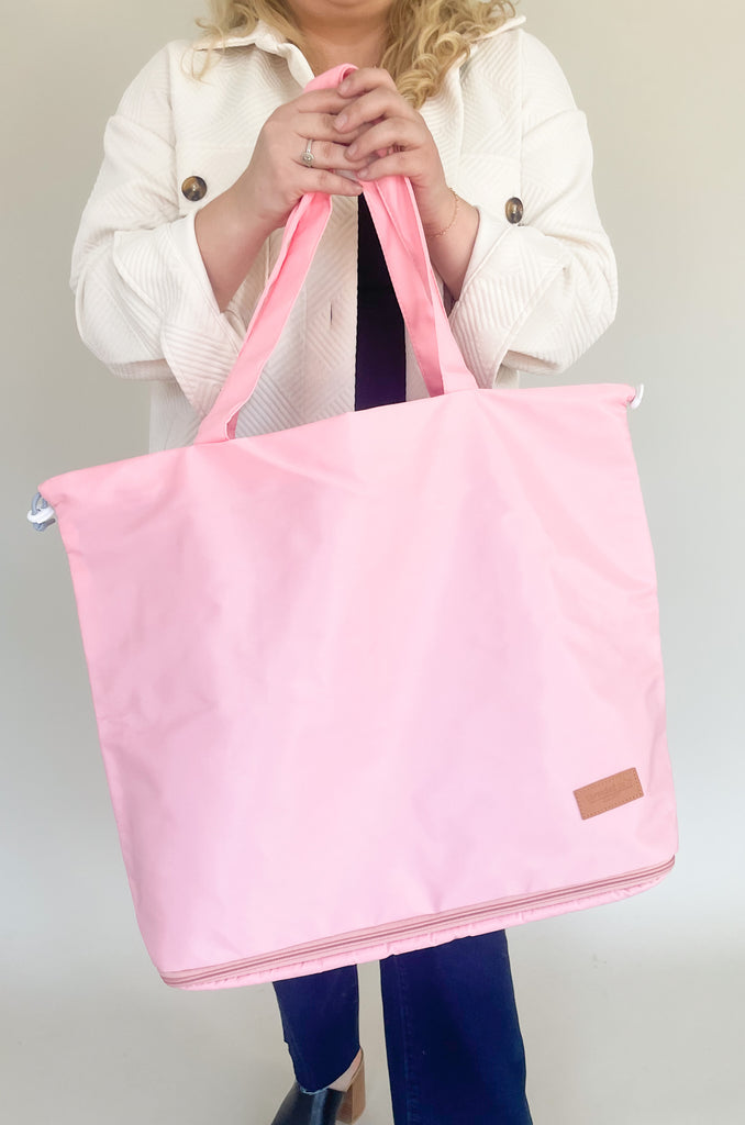 Get organized on-the-go with this fun tote! It has a zipper bottom, perfect for shoes and extra storage. It closes on the top with two drawstrings on the side. 