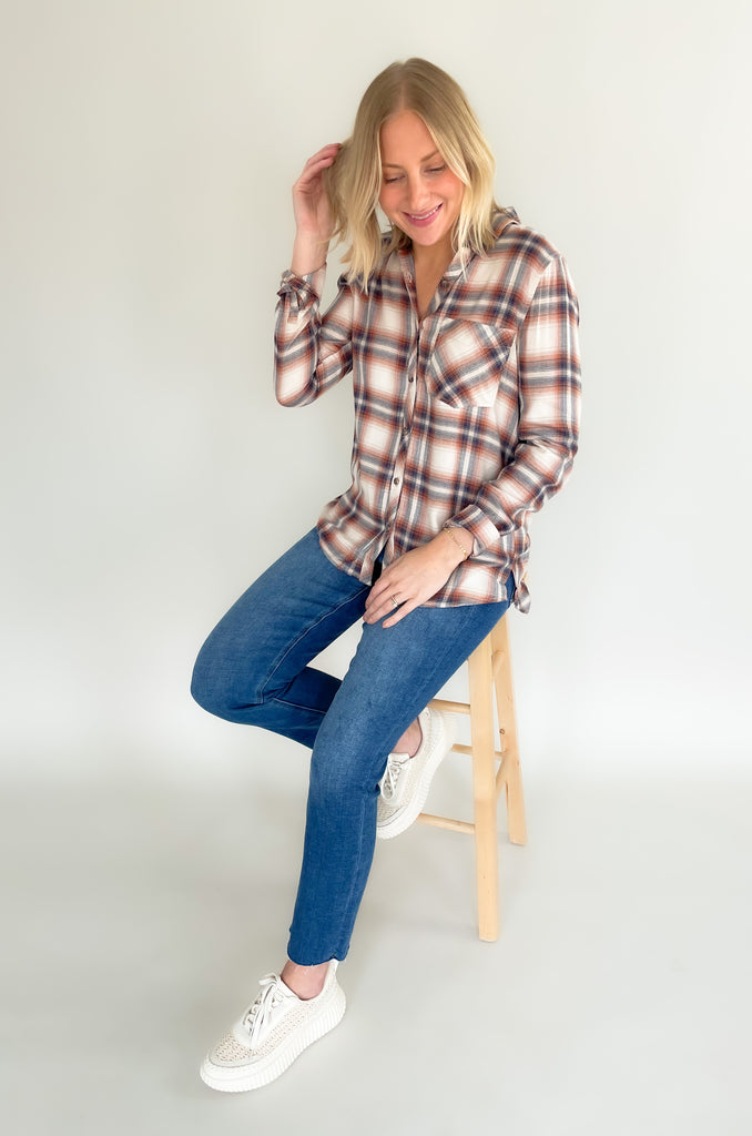 Cozy up this season in the Carson Carmel & Navy Lightweight Flannel! Crafted from lightweight material for breathability, this flannel is designed to keep you warm without the bulk. It has a soft, brushed fabric. On the front, there's a single pocket and collar detail. With its soft caramel and navy hue, this flannel looks as great as it feels!
