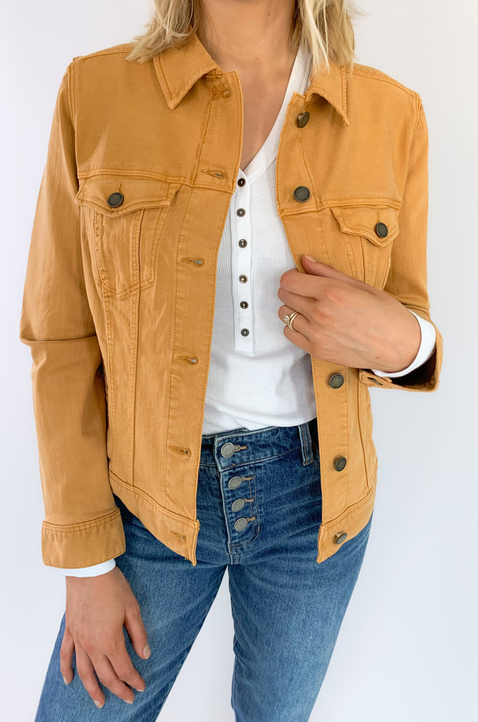 The Liverpool Los Angeles Classic Amber Dawn Jean Jacket is perfect for fall! The color is a unique cross between a burnt mustard and orange. With amazing stretch and recovery, this classic jean jacket will be your new go-to layering piece. It adds a unique touch to any look and a little pop of color.