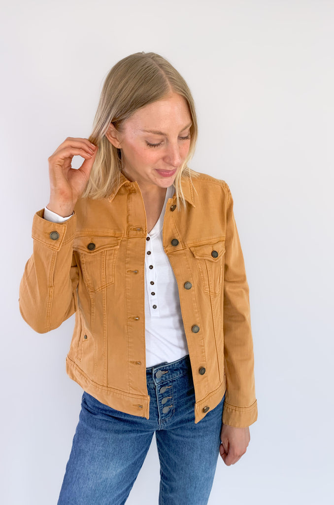 The Liverpool Los Angeles Classic Amber Dawn Jean Jacket is perfect for fall! The color is a unique cross between a burnt mustard and orange. With amazing stretch and recovery, this classic jean jacket will be your new go-to layering piece. It adds a unique touch to any look and a little pop of color.