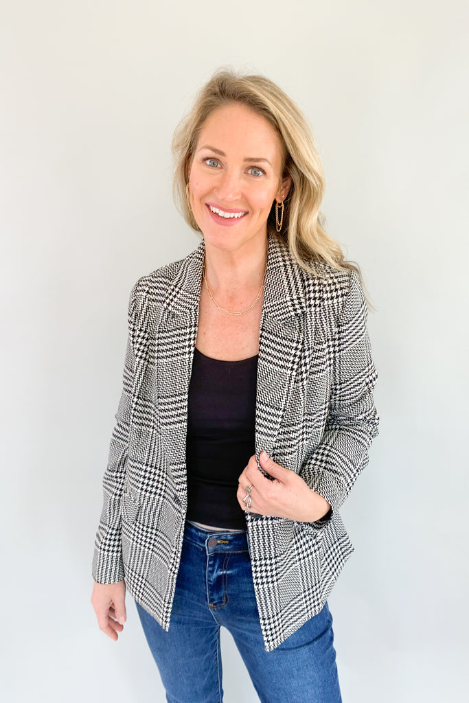 Look sophisticated and chic in this classic black and off-white plaid blazer! Its fashionable design guarantees a timeless look that you'll love wearing all the time. You can wear it through many seasons, but would be gorgeous for holidays or work. We kept our look casual by pairing it with a basic tank and denim. 
