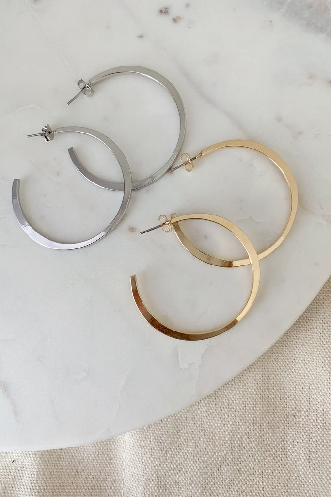 Try the Classic Sleek Hoop Earrings for a timeless look! These earrings are a jewelry staple with a sleek design and are available in either gold or silver to perfectly suit any style. With a post backing, you can comfortably wear these all day!