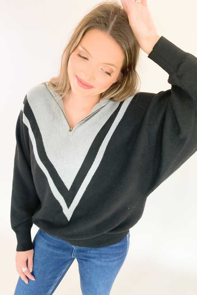 This Elan Collared Dual V Sweater is the perfect combination of cozy comfort and timeless style! With elevated fabric and soft feel, you'll look and feel your best in any setting. It has a preppy flare with the black and and grey stripe details along the neckline, as well as the zip collar. This sweater is undoubtedly a comfortable option for everyday.  