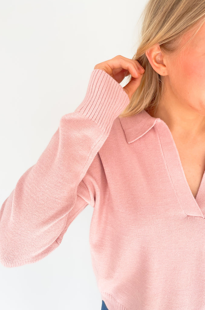 Gray, dusty pink, or charcoal collard sweaters that are cozy and comfortable while still being stylish. Features a ribbed waistline and collar. Hits at the waistline