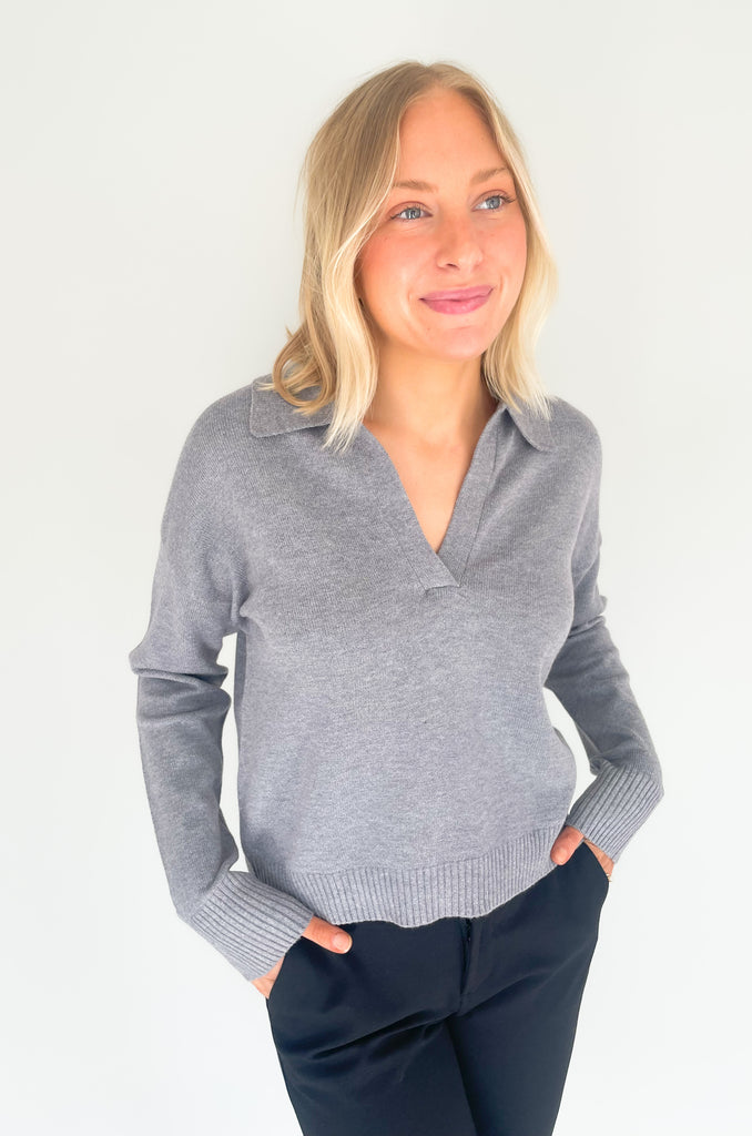 Gray, dusty pink, or charcoal collard sweaters that are cozy and comfortable while still being stylish. Features a ribbed waistline and collar. Hits at the waistline