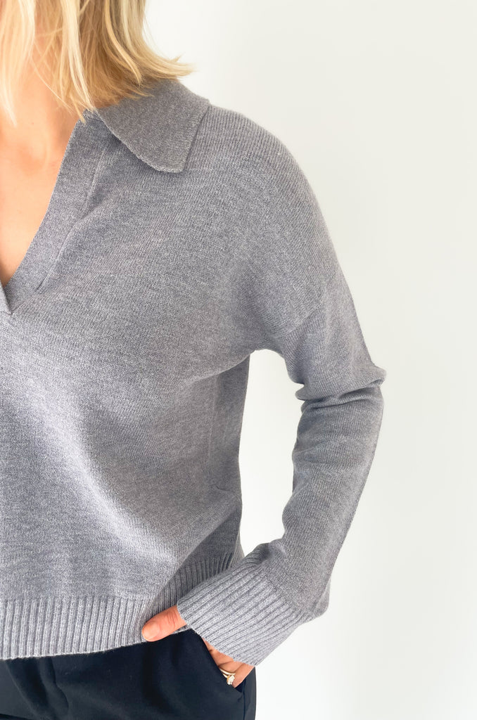 Gray, dusty pink, or charcoal collard sweaters that are cozy and comfortable while still being stylish. Features a ribbed waistline and collar. Hits at the waistline