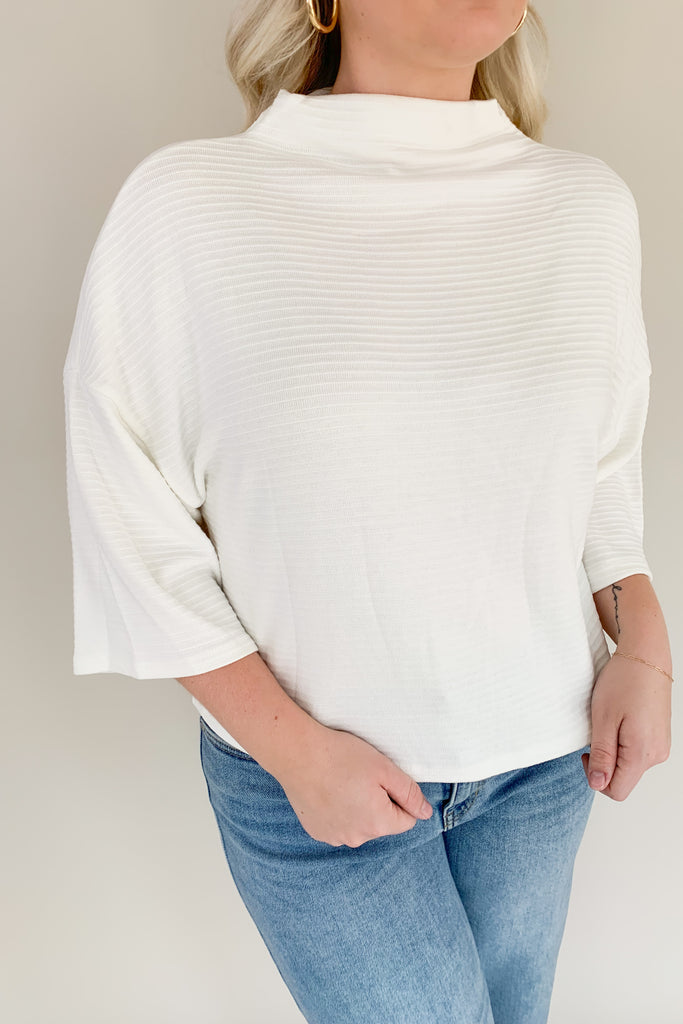 Find confidence in our new Corinne Sweater! This elevated combo between a tee and a sweater creates the perfect blend of comfort and elegance. It features a cowl neckline and flowy batwing 3/4 sleeves with ribbing for extra texture. Fun and confident, this sweater is perfect for any outfit!