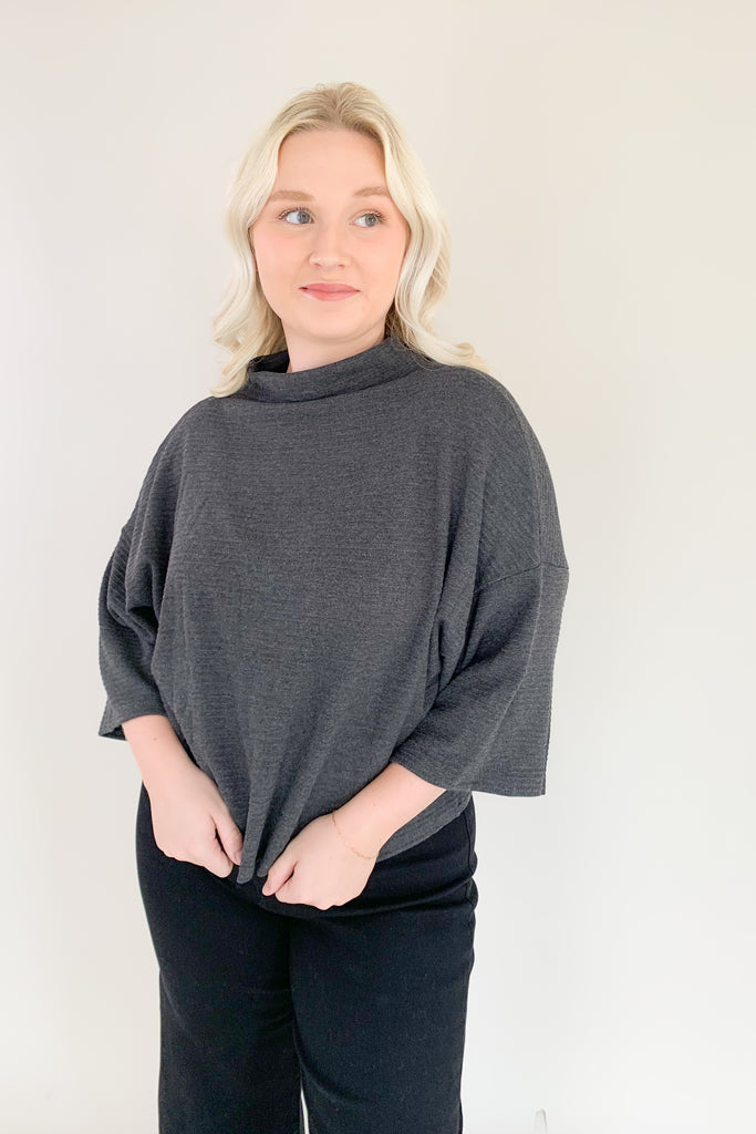 Find confidence in our new Corinne Sweater! This elevated combo between a tee and a sweater creates the perfect blend of comfort and elegance. It features a cowl neckline and flowy batwing 3/4 sleeves with ribbing for extra texture. Fun and confident, this sweater is perfect for any outfit!