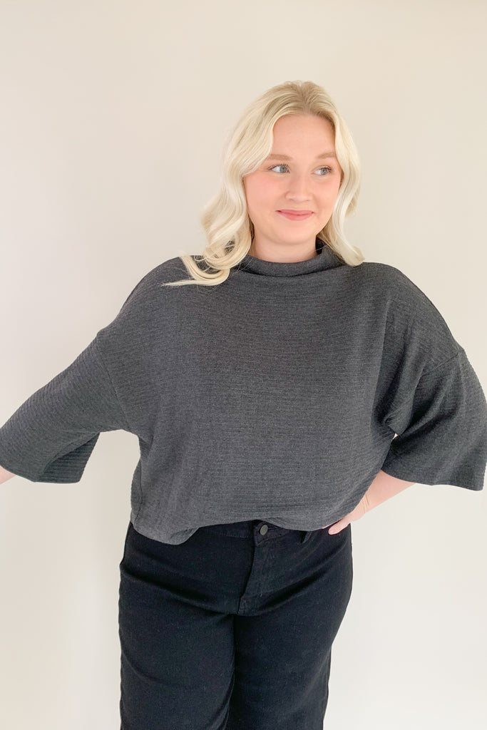 Find confidence in our new Corinne Sweater! This elevated combo between a tee and a sweater creates the perfect blend of comfort and elegance. It features a cowl neckline and flowy batwing 3/4 sleeves with ribbing for extra texture. Fun and confident, this sweater is perfect for any outfit!