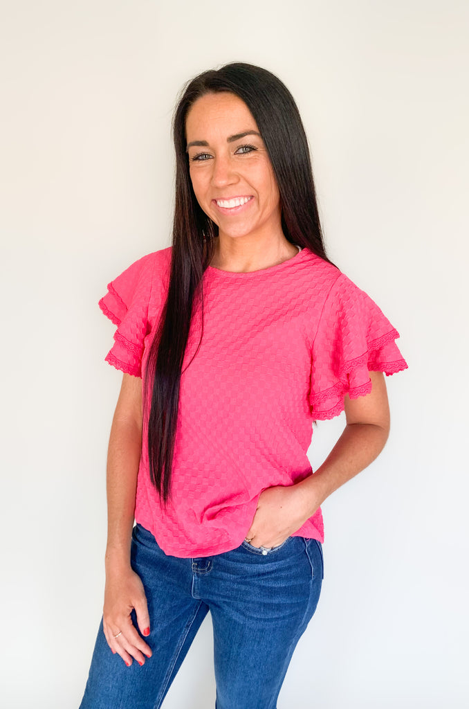  Our Daily Double Ruffle Textured Short Sleeve Blouse adds a chic touch to any wardrobe. Enjoy a sweet ruffle sleeve, a delicate lace trim on the ruffles, and a modern checkered pattern to give this blouse an elegant look! Perfect to be worn alone or under a blazer for a more formal look! 