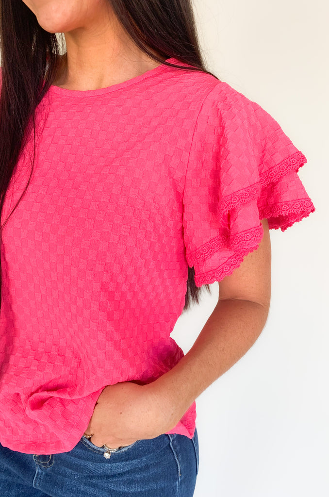  Our Daily Double Ruffle Textured Short Sleeve Blouse adds a chic touch to any wardrobe. Enjoy a sweet ruffle sleeve, a delicate lace trim on the ruffles, and a modern checkered pattern to give this blouse an elegant look! Perfect to be worn alone or under a blazer for a more formal look! 