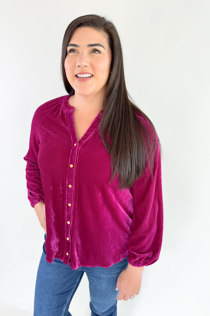 Bring holiday cheer to your wardrobe with this soft, stretchy dark magenta long sleeve velour top! Featuring a flattering silhouette with balloon sleeves, a flowy body, and pretty gold buttons, you will reaching for this stunner time and time again. It's perfect for special occasions and work, while adding a fun and confident touch to any look!