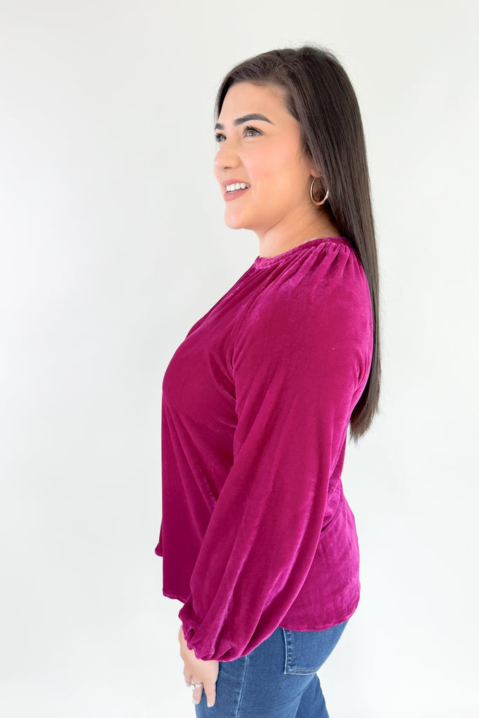 Bring holiday cheer to your wardrobe with this soft, stretchy dark magenta long sleeve velour top! Featuring a flattering silhouette with balloon sleeves, a flowy body, and pretty gold buttons, you will reaching for this stunner time and time again. It's perfect for special occasions and work, while adding a fun and confident touch to any look!