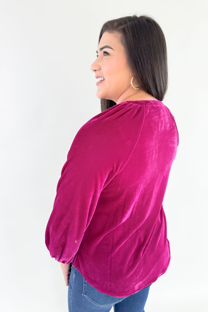 Bring holiday cheer to your wardrobe with this soft, stretchy dark magenta long sleeve velour top! Featuring a flattering silhouette with balloon sleeves, a flowy body, and pretty gold buttons, you will reaching for this stunner time and time again. It's perfect for special occasions and work, while adding a fun and confident touch to any look!
