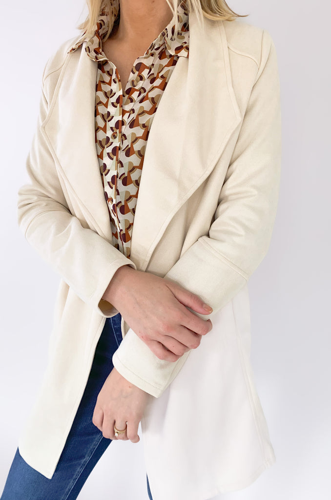 faux suede jacket that exudes sophistication with its collared details and drape front cut, while remaining lightweight and comfortable- available in ecru and dusty lavender
