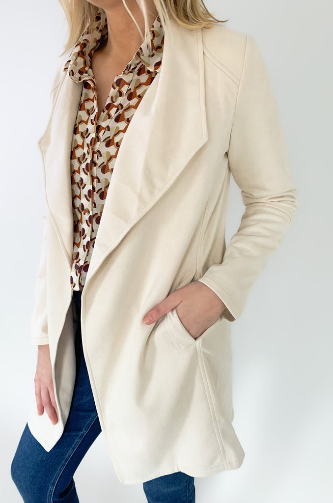 faux suede jacket that exudes sophistication with its collared details and drape front cut, while remaining lightweight and comfortable- available in ecru and dusty lavender