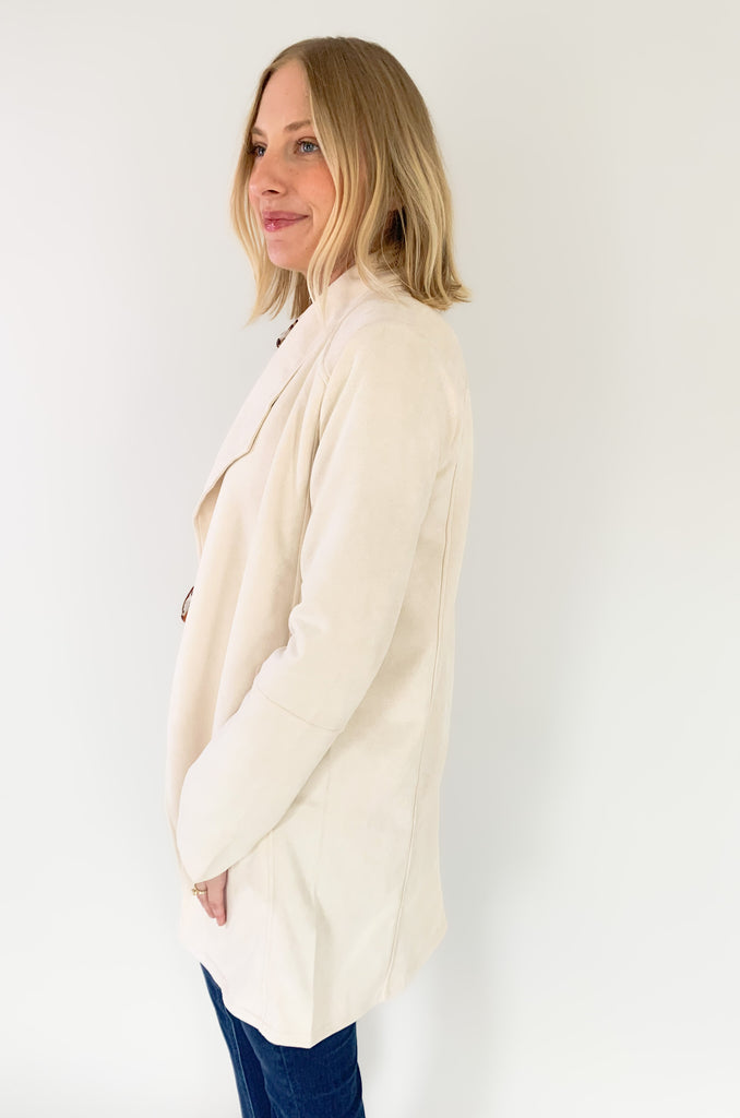 faux suede jacket that exudes sophistication with its collared details and drape front cut, while remaining lightweight and comfortable- available in ecru and dusty lavender