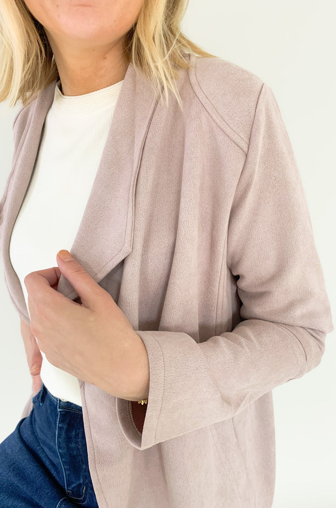 faux suede jacket that exudes sophistication with its collared details and drape front cut, while remaining lightweight and comfortable- available in ecru and dusty lavender