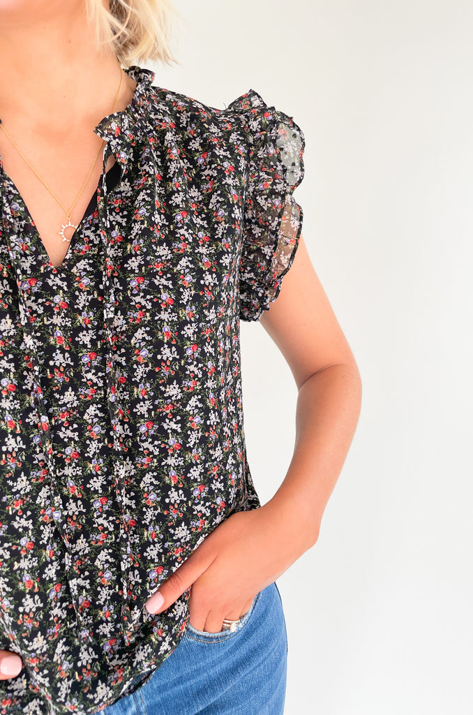 This stunning top is made of a lightweight, sheer material with a matching underlay for an elegant touch. Delicate gold thread runs throughout the shirt, while the ruffle sleeves and drawstring neckline add extra flair and structure. Perfect for any occasion, this top will make a statement.