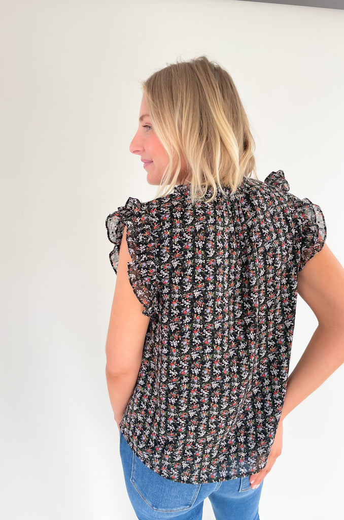 This stunning top is made of a lightweight, sheer material with a matching underlay for an elegant touch. Delicate gold thread runs throughout the shirt, while the ruffle sleeves and drawstring neckline add extra flair and structure. Perfect for any occasion, this top will make a statement.