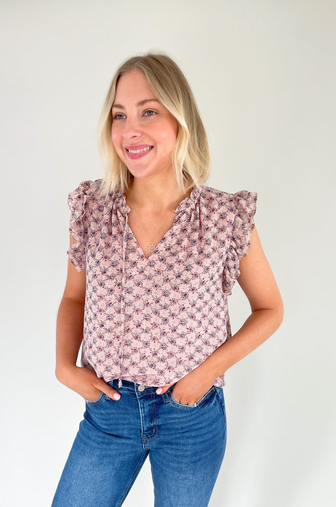 This stunning top is made of a lightweight, sheer material with a matching underlay for an elegant touch. Delicate gold thread runs throughout the shirt, while the ruffle sleeves and drawstring neckline add extra flair and structure. Perfect for any occasion, this top will make a statement.