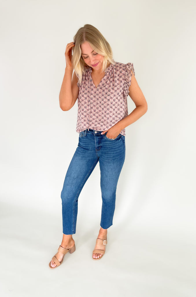 This stunning top is made of a lightweight, sheer material with a matching underlay for an elegant touch. Delicate gold thread runs throughout the shirt, while the ruffle sleeves and drawstring neckline add extra flair and structure. Perfect for any occasion, this top will make a statement.