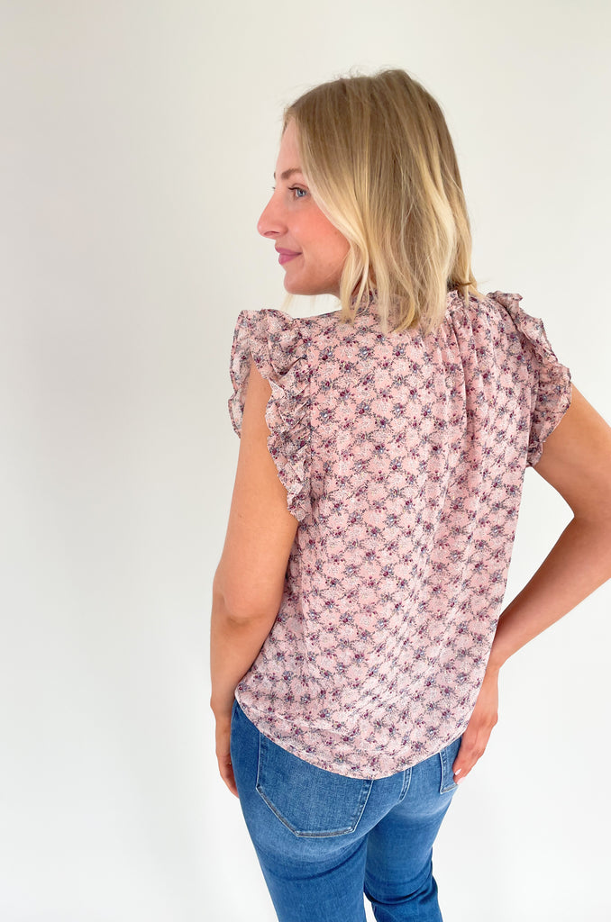 This stunning top is made of a lightweight, sheer material with a matching underlay for an elegant touch. Delicate gold thread runs throughout the shirt, while the ruffle sleeves and drawstring neckline add extra flair and structure. Perfect for any occasion, this top will make a statement.